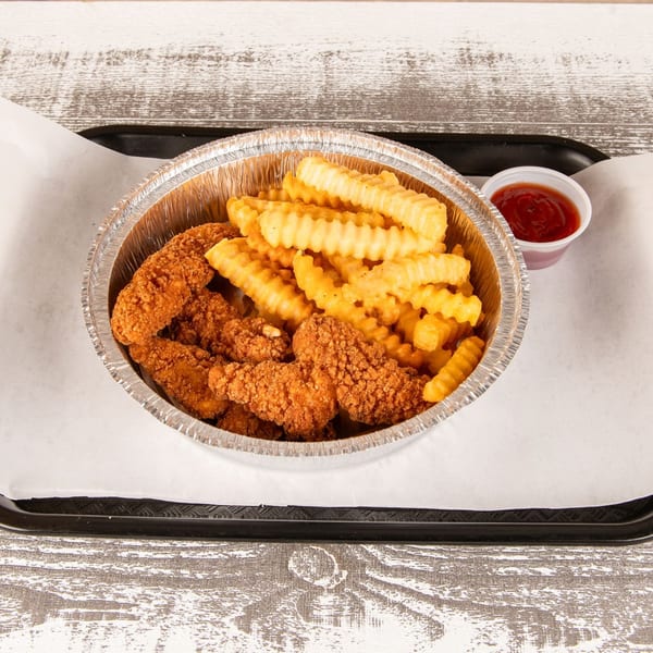 Crispy chicken tenders and crinkle-cut fries in a foil container with a side of ketchup.